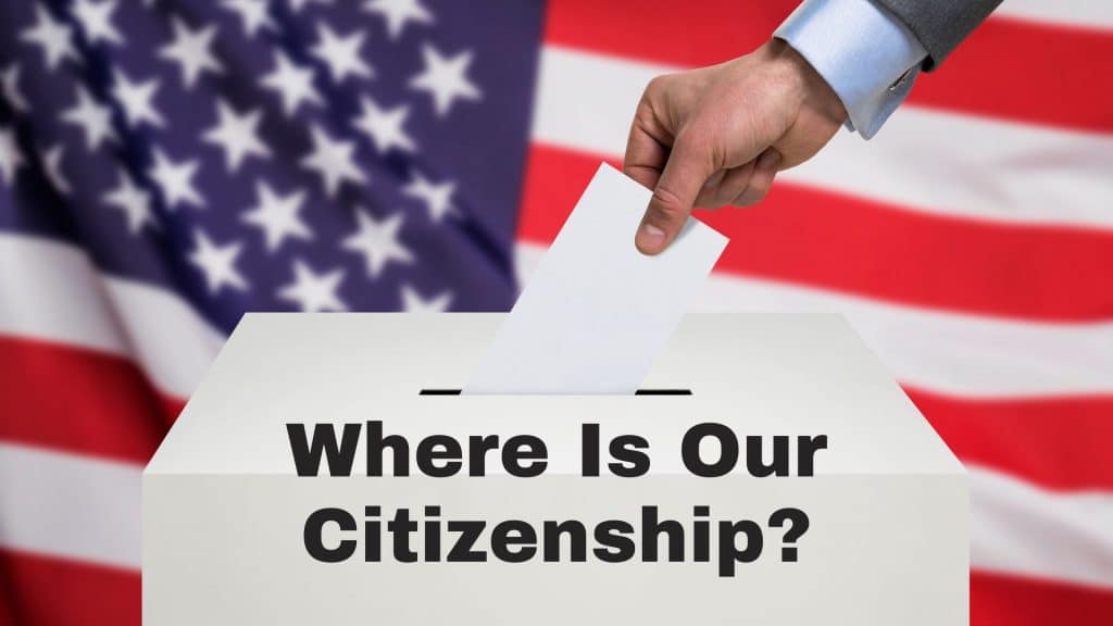 hand placing a ballot in a ballot box, USA flag backdrop