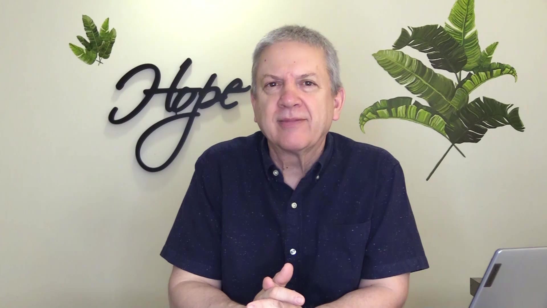 Pastor Paul sitting at desk, presenting podcast