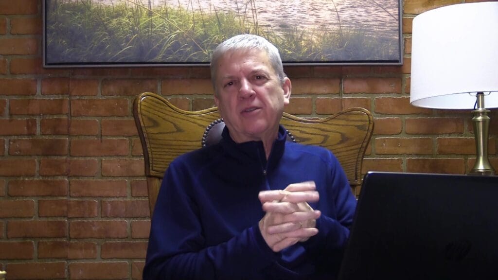 Pastor Paul sitting at desk, presenting podcast